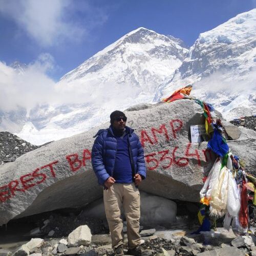 Navaraj Thapa at the Everest Base Camp marker rock, 5,364 m