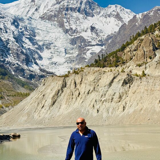 Navaraj Thapa beside Blue Lake on the way to Manang, a large snow peak behind